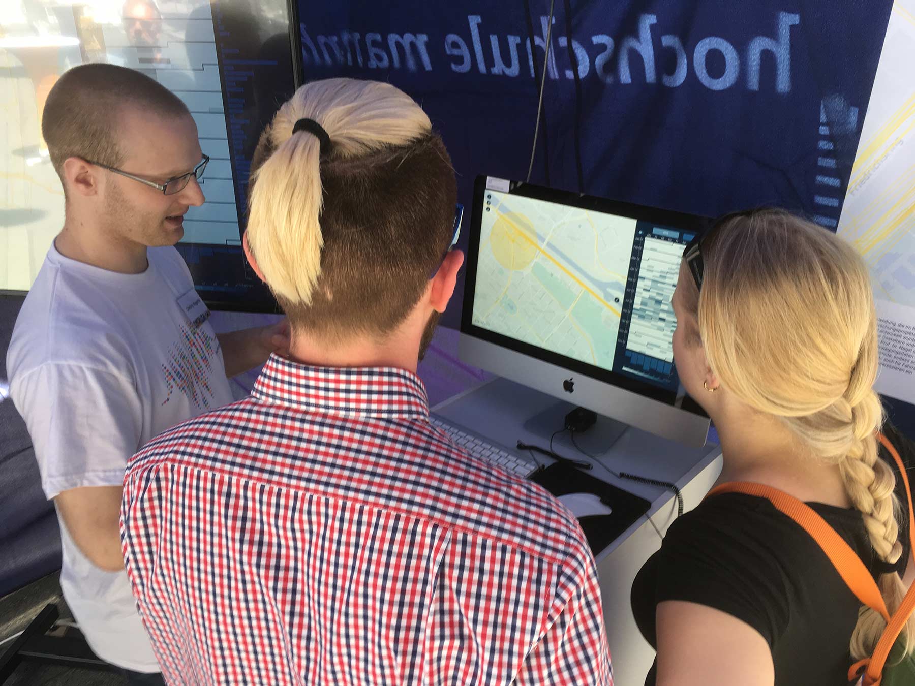 A group member explaining the visualization system to interested citizens.